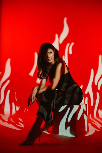 Striking fashion portrait of a model against a creative red backdrop in Baku, Azerbaijan.