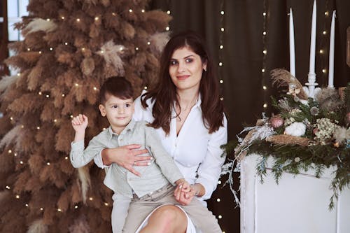 Free Smiling Mother Sitting with Son Stock Photo