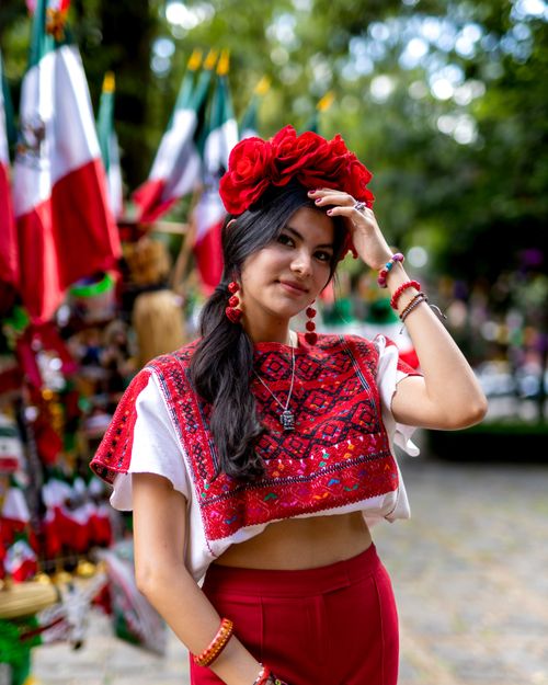 Free A woman in traditional Mexican attire celebrating with vibrant colors and a joyful expression. Stock Photo