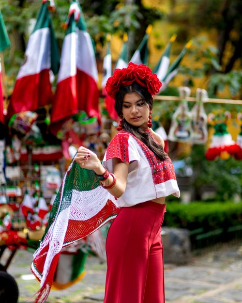 Free Woman in traditional Mexican attire celebrating at an outdoor festival. Stock Photo