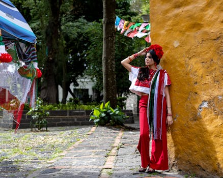 A woman in traditional Mexican attire in a colorful outdoor festive setting.
