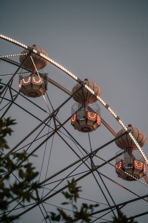 Illuminated Cabins on Ferris Wheel on Sunset