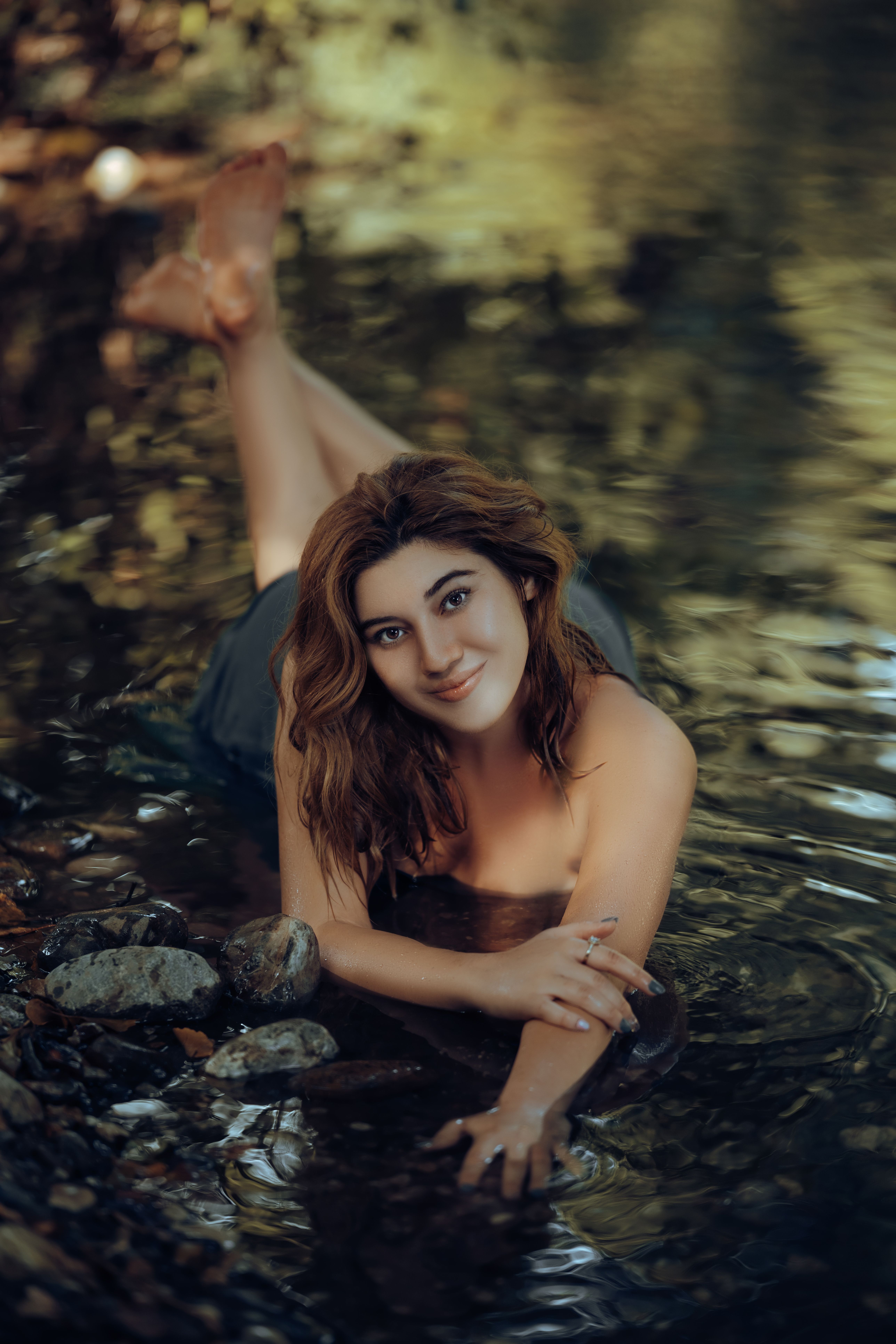 Young Woman Lying in Water in Nature · Free Stock Photo