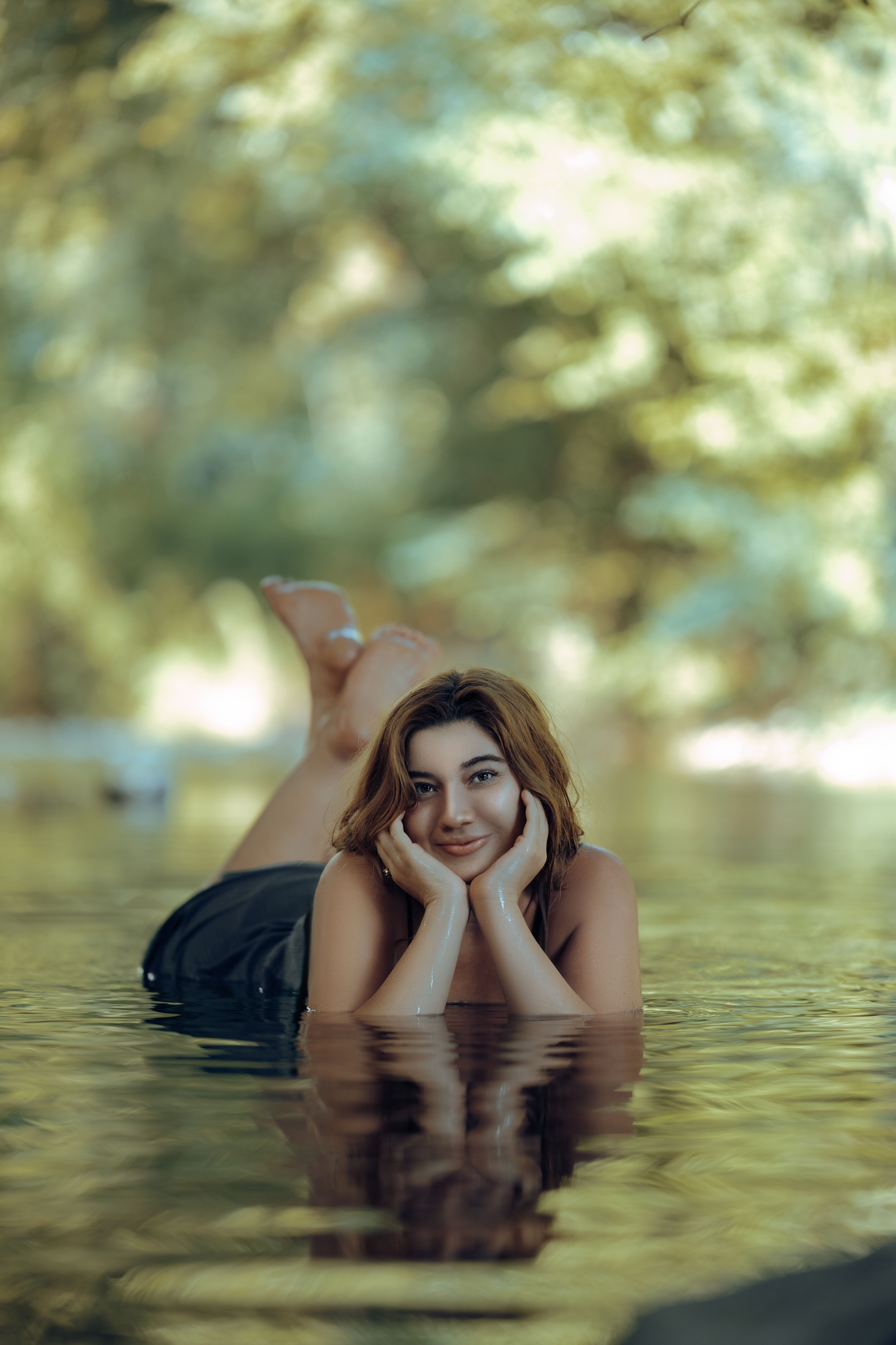 Smiling Woman Lying in Water in Nature · Free Stock Photo
