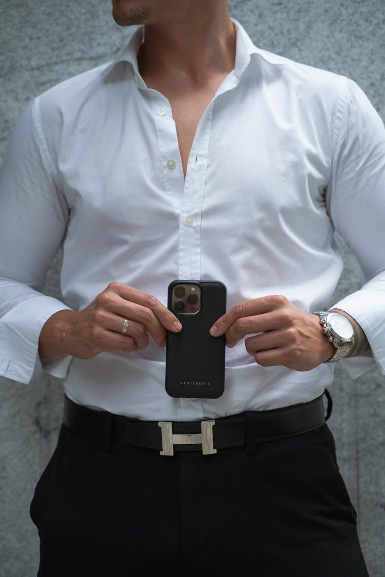 Man In White Shirt Holding Black Smartphone In Case