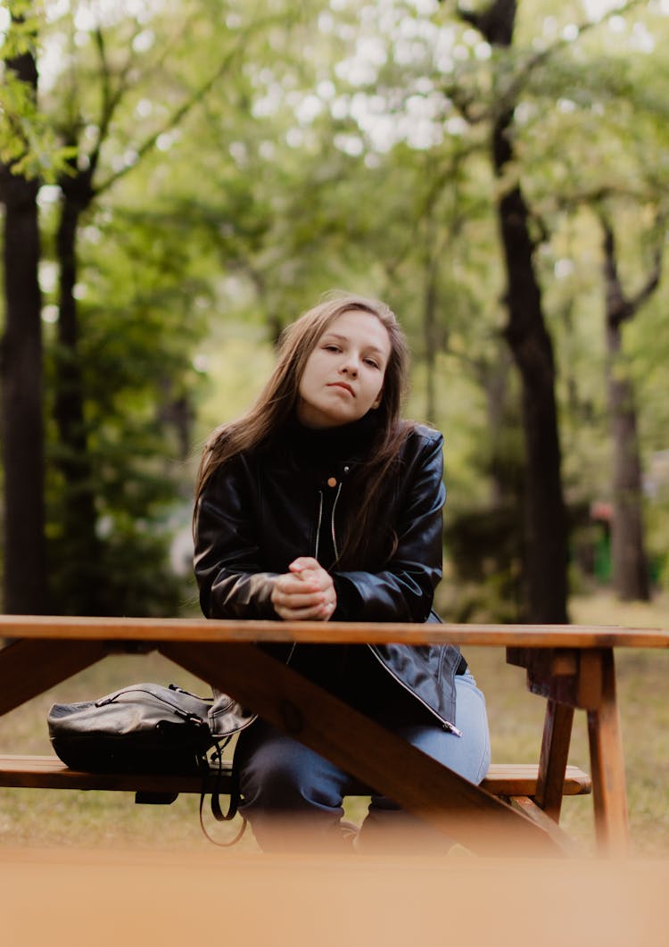 Woman In Leather Jacket In Park