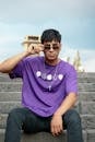 Man Sitting in Purple T-shirt