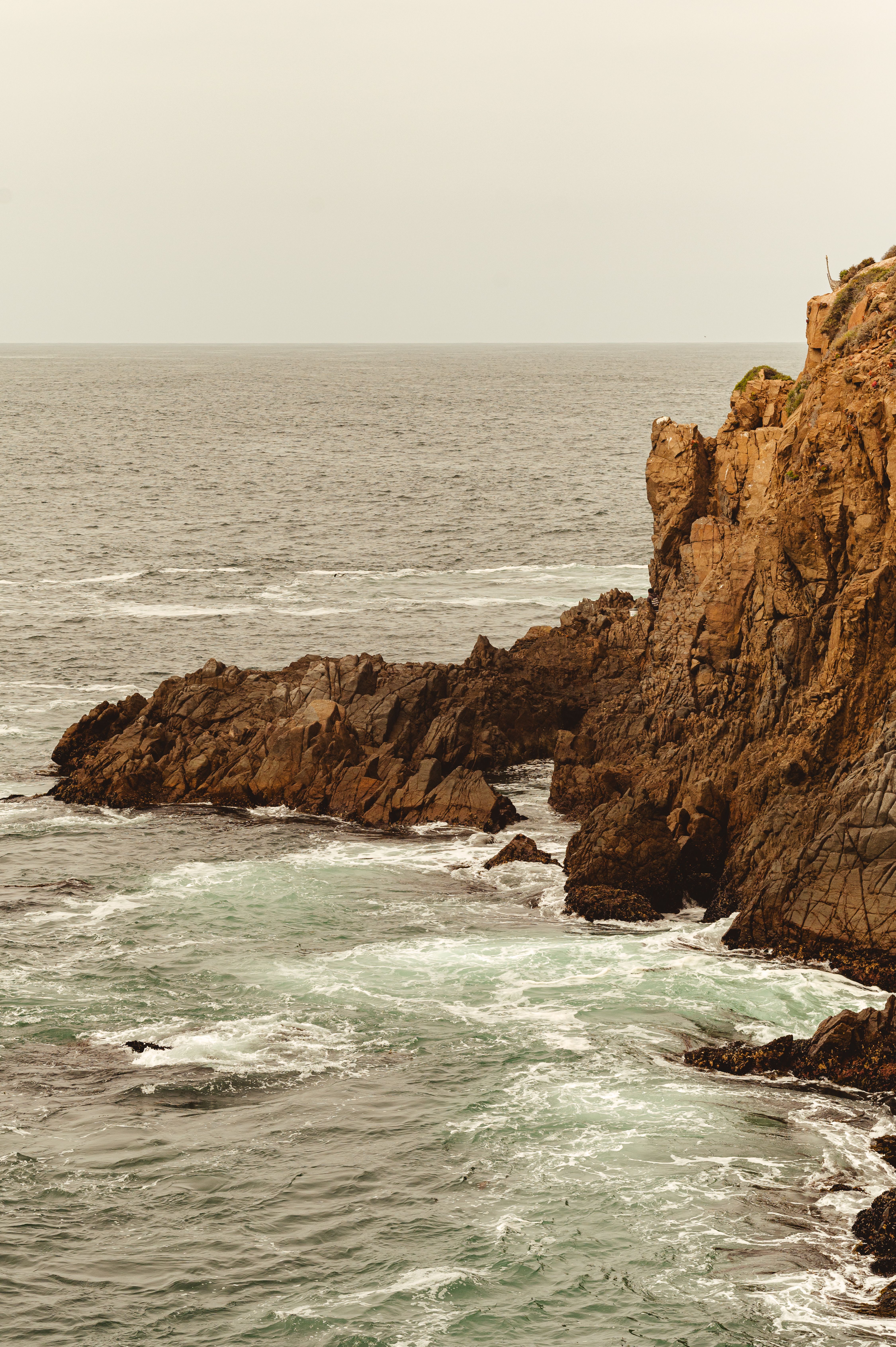 Rocky Cliff on the Ocean Shore · Free Stock Photo