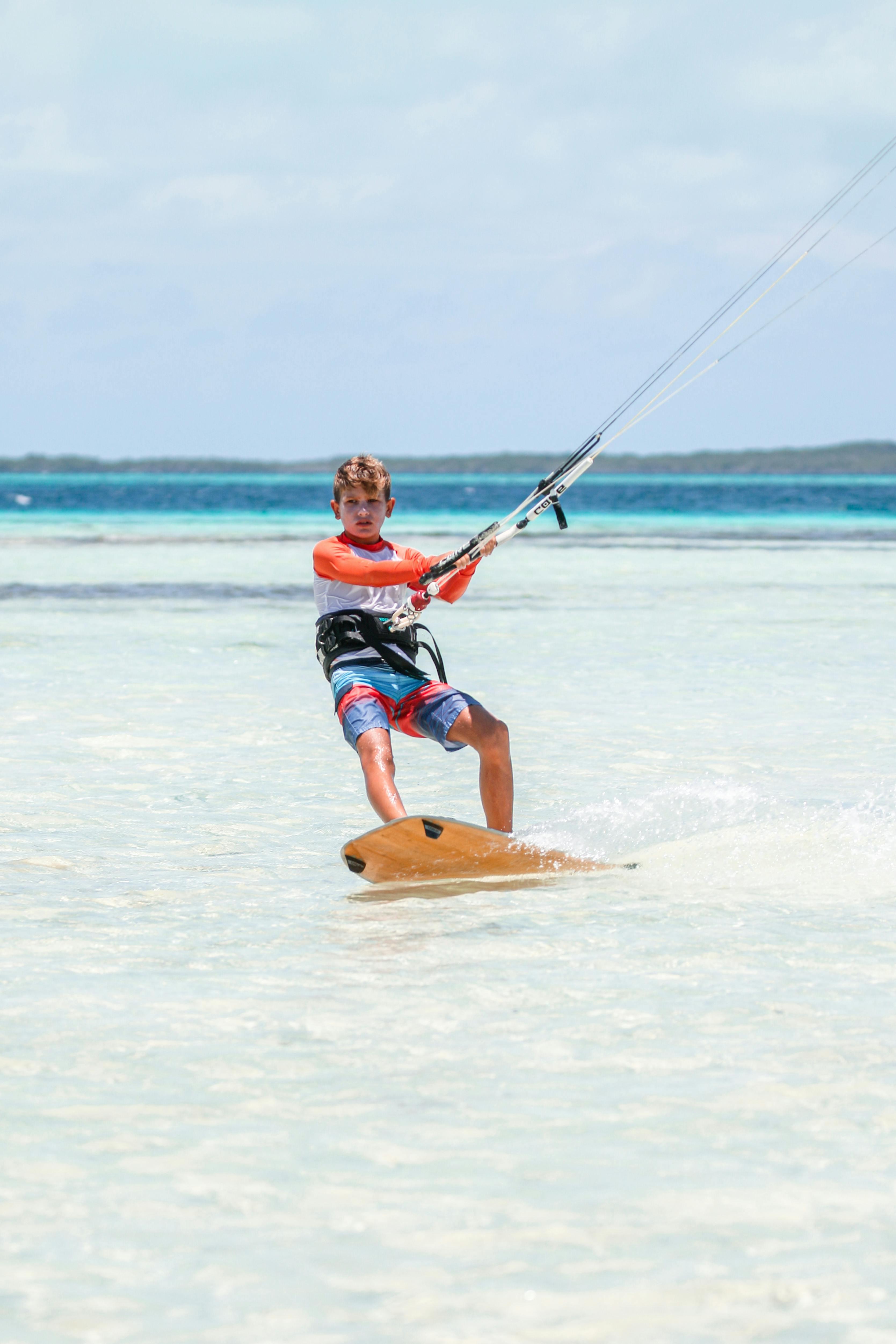 kitesurfing teenager on sea coast