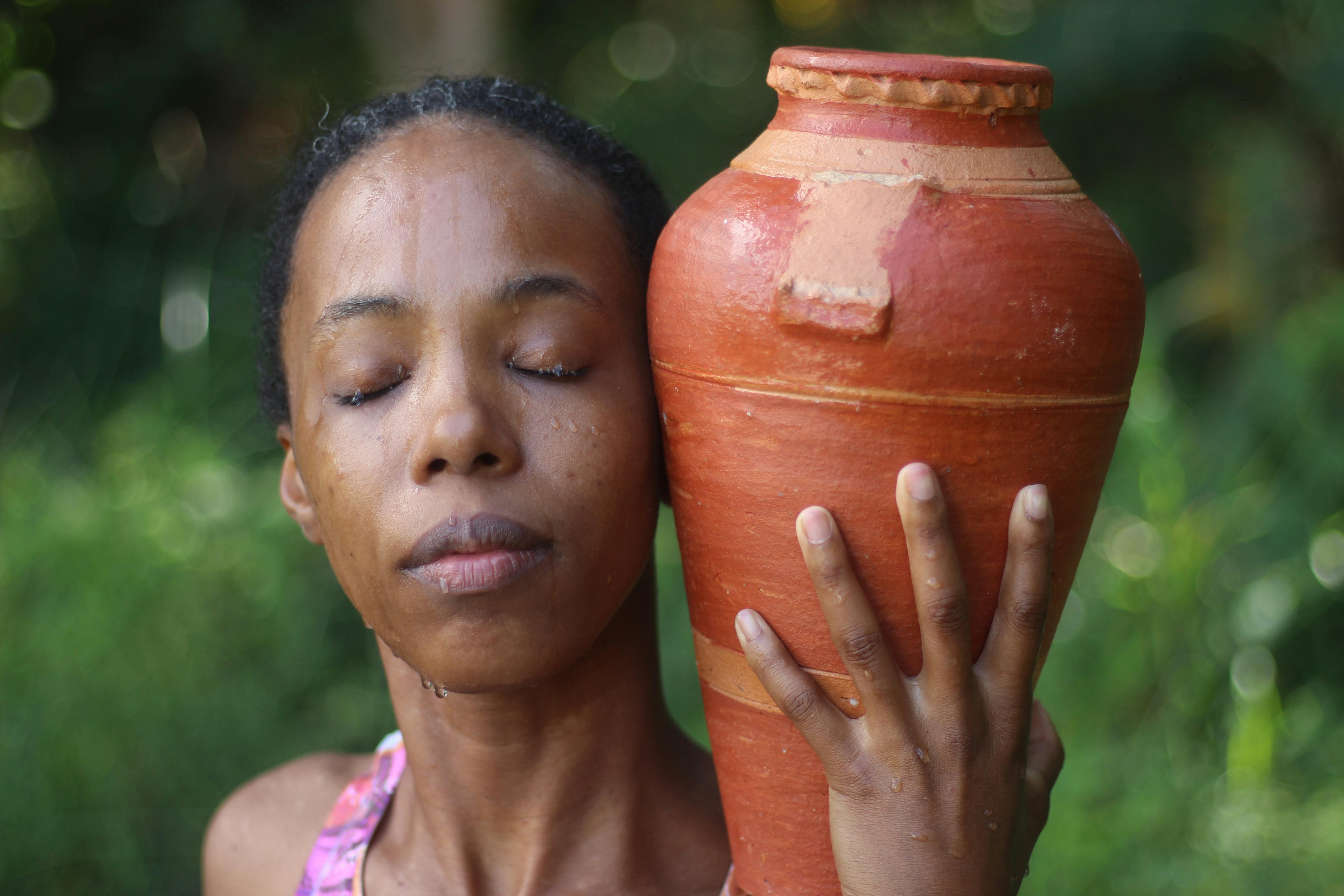 Young Woman Posing with a Clay Water Jug · Free Stock Photo