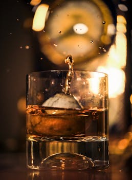 Captivating close-up shot of a splash in a whiskey glass, highlighting the dynamics of liquid motion.