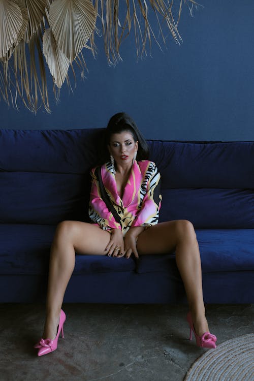 Brunette Woman Sitting and Posing in Colorful Jacket