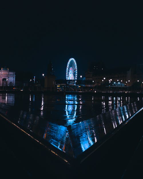 Illuminated Ferries Wheel in City at Night