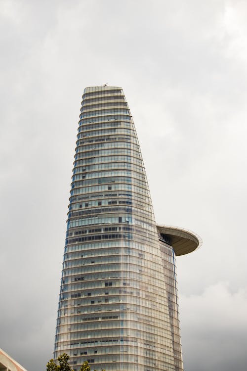 Bitexco Financial Tower Skyscraper against Cloudy Sky in Ho Chi Minh City, Vietnam