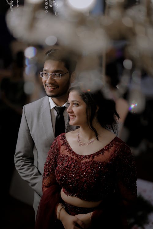 Smiling Newlyweds in Suit and Traditional Clothing