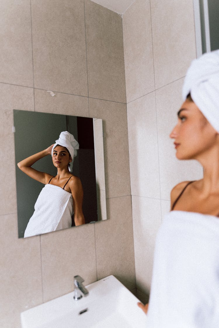 Woman Reflection In Mirror In Bathroom