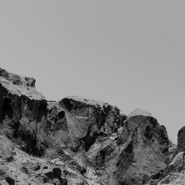 Scenic black and white rocks with heart carving in Canoa Quebrada, Brazil capturing natural beauty.