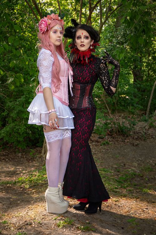 Free Two women in elegant cosplay costumes posing outdoors in Leipzig, Germany. Stock Photo