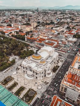 Stunning aerial shot of Palacio de Bellas Artes amidst the bustling cityscape of Mexico City.