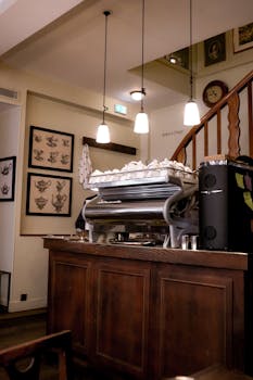 Warm Parisian cafe interior featuring a classic espresso machine and wooden furnishings.