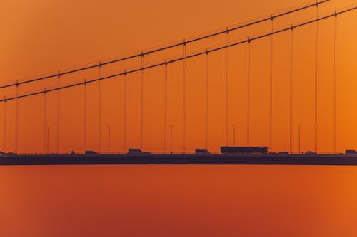 Silhouettes of Cars on the Second Bosphorus Bridge Against the Orange Sky at Sunset