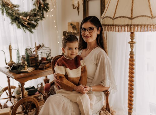 Happy Mother Posing with Boy on Armchair