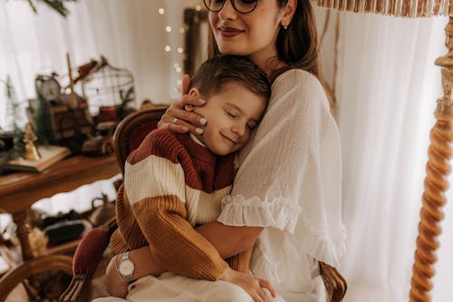 Brunette Woman Embracing Son