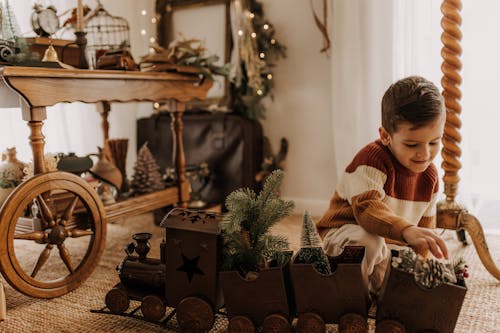 Boy Playing with Wooden Train Toy During Christmas
