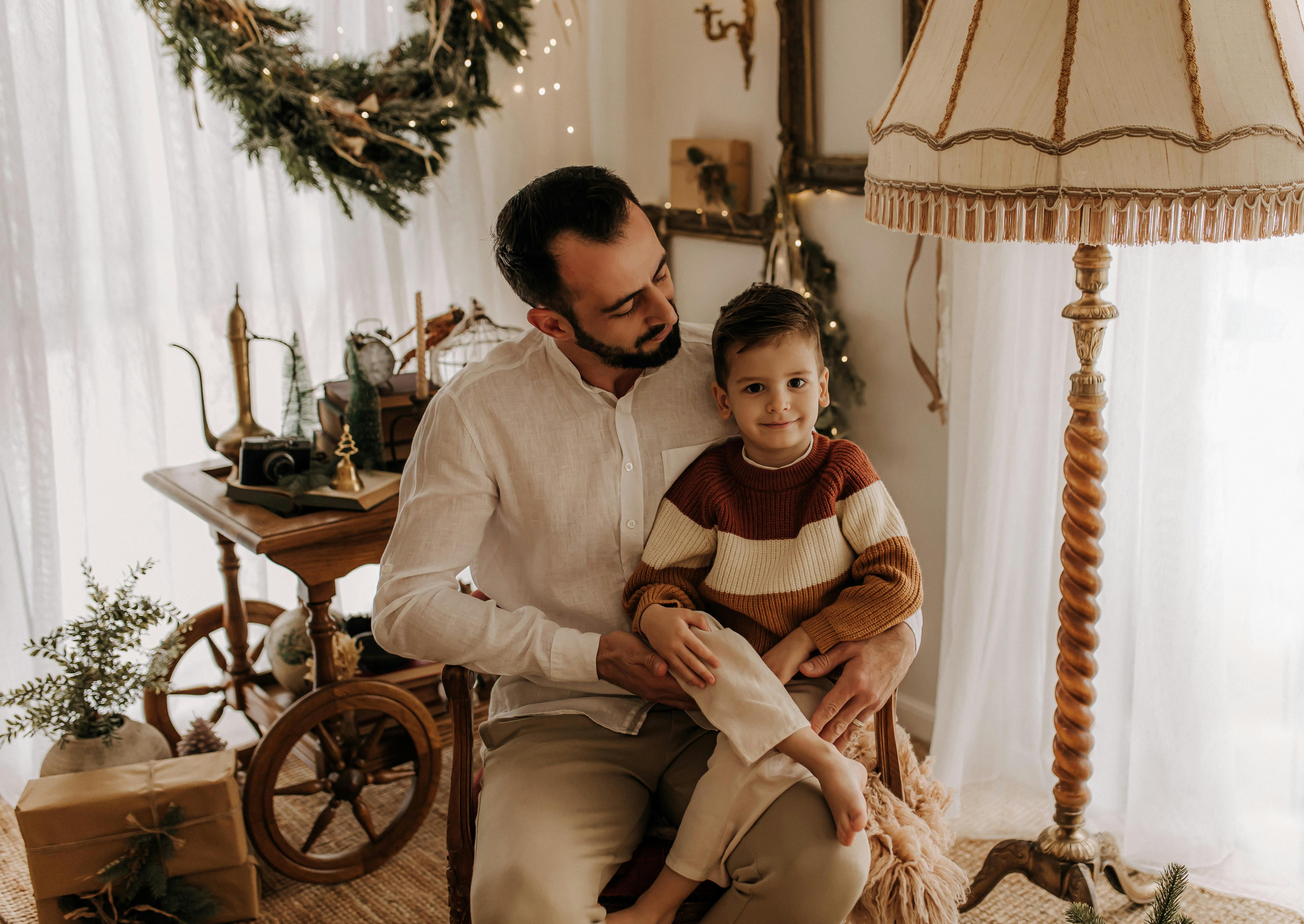 Cozy Christmas setting with father and son indoors, capturing celebration and love.