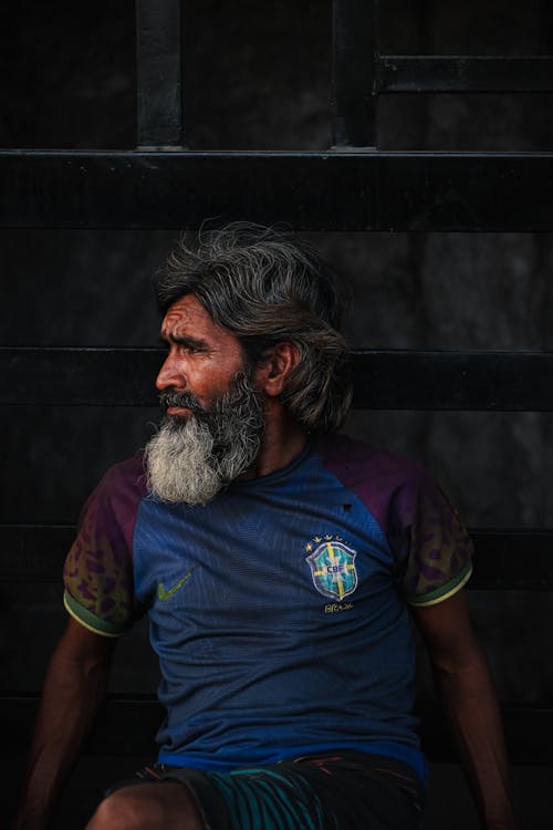 Man Sitting in Brazil Soccer Jersey