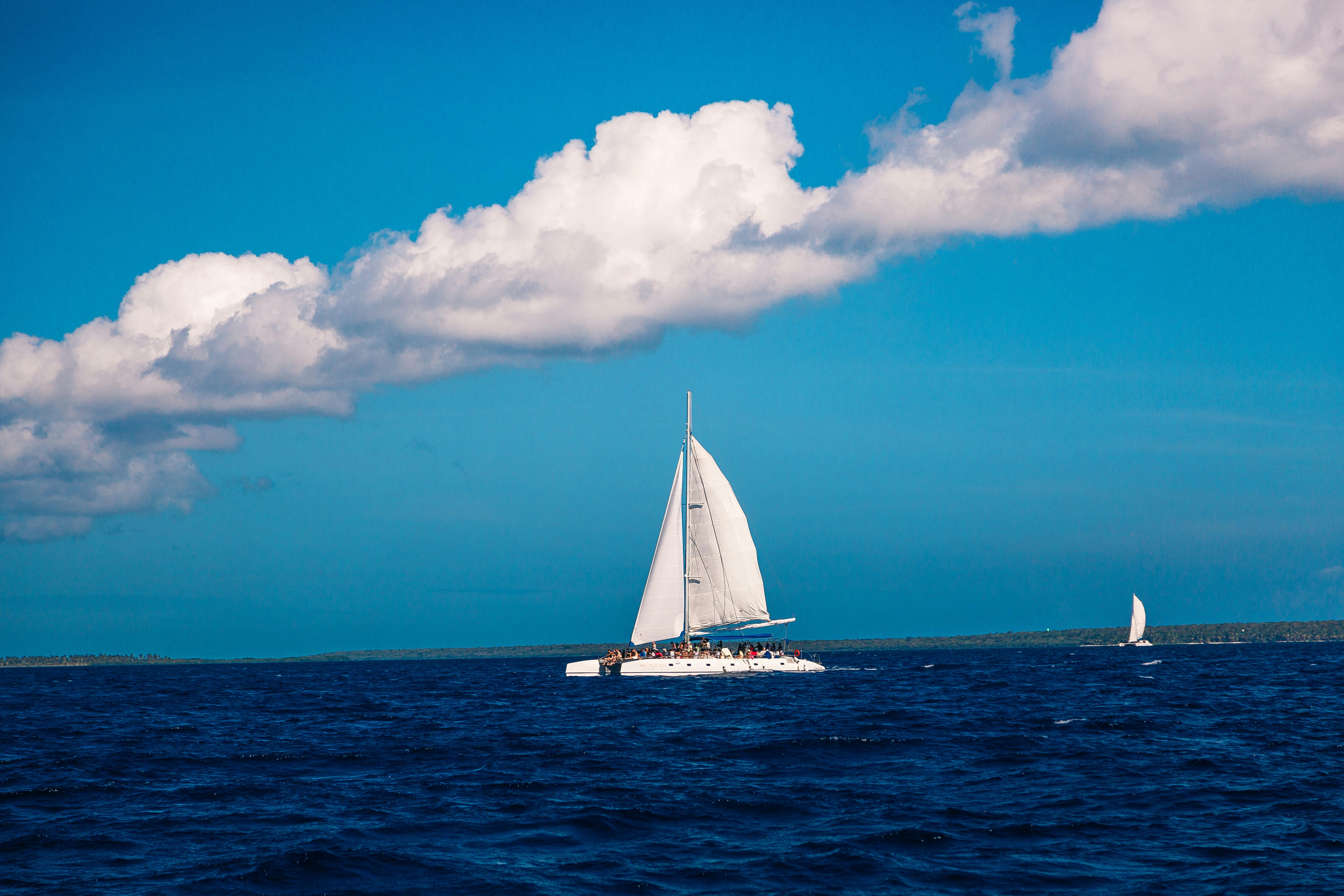 A Sailboat on the Water under Blue Sky Free Stock Photo