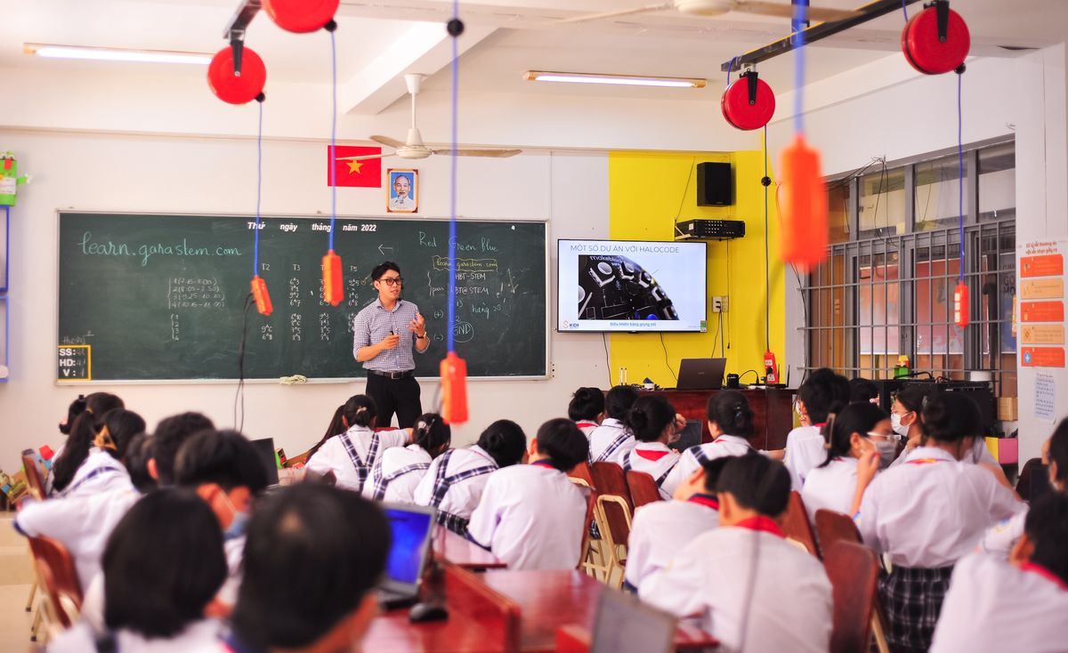 Teacher leading an interactive classroom lesson with students.