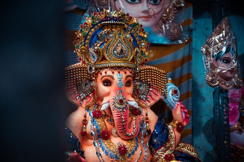 Free Colorful Ganesha idol adorned with ornaments, symbolizing Hindu culture in Kolkata market, India. Stock Photo