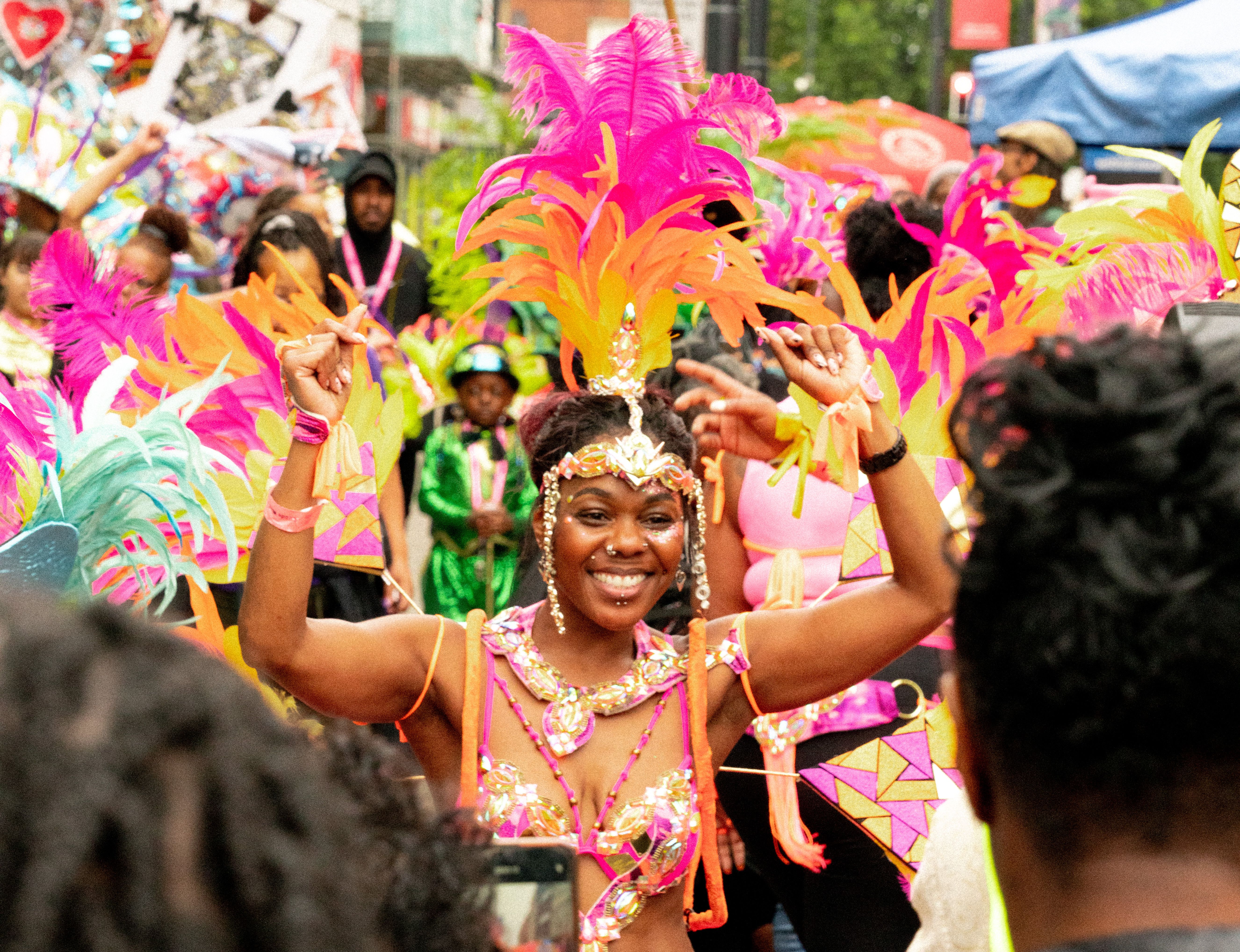 Carnival performers wearing vibrant costumes at Notting Hill Carnival