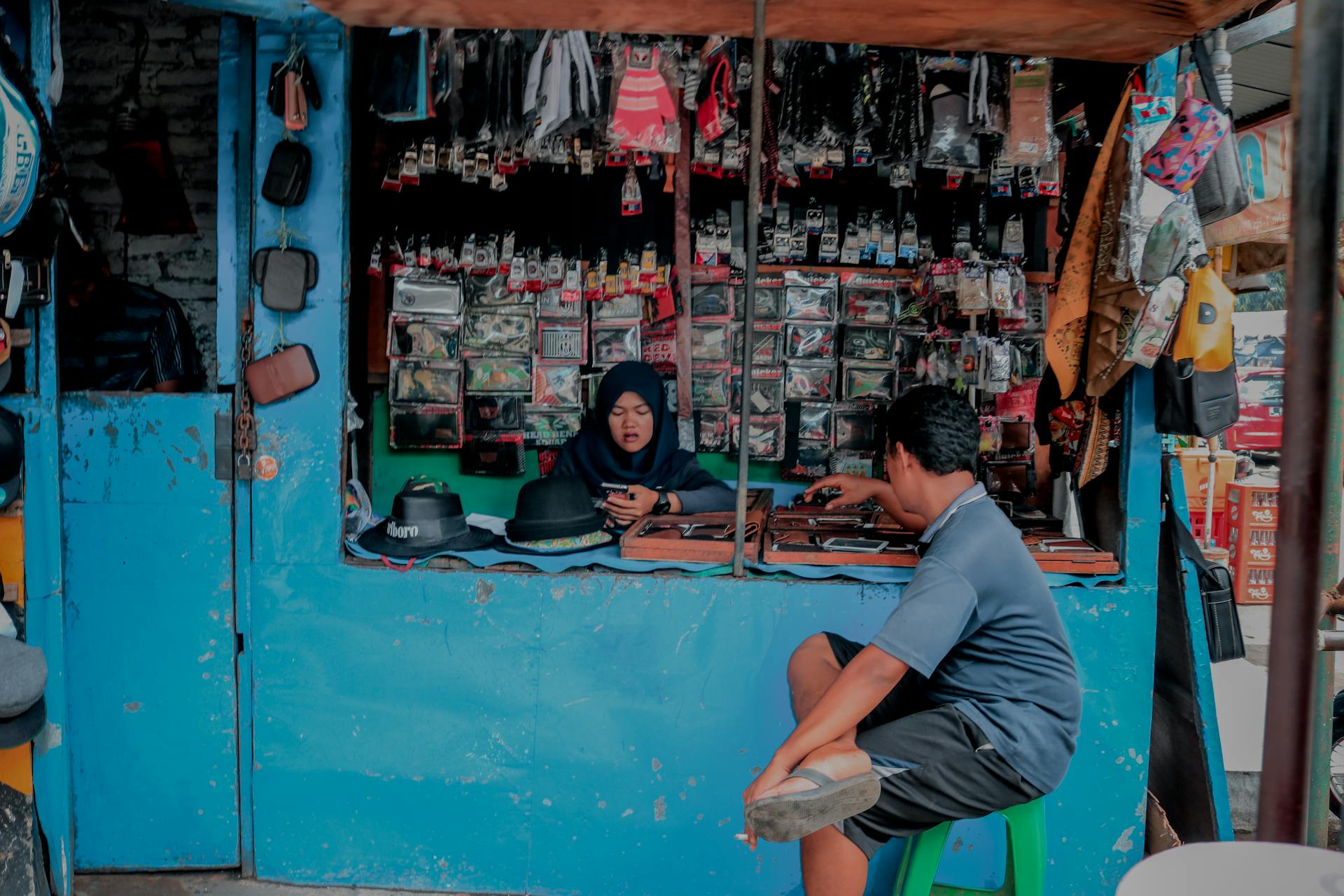 A vibrant traditional market stall in Indonesia showcasing local goods and interactions.