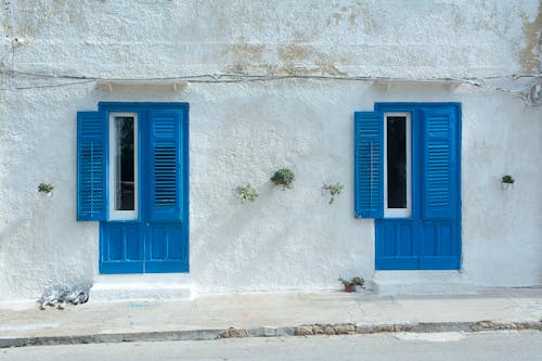 A White Building with Blue Shutters