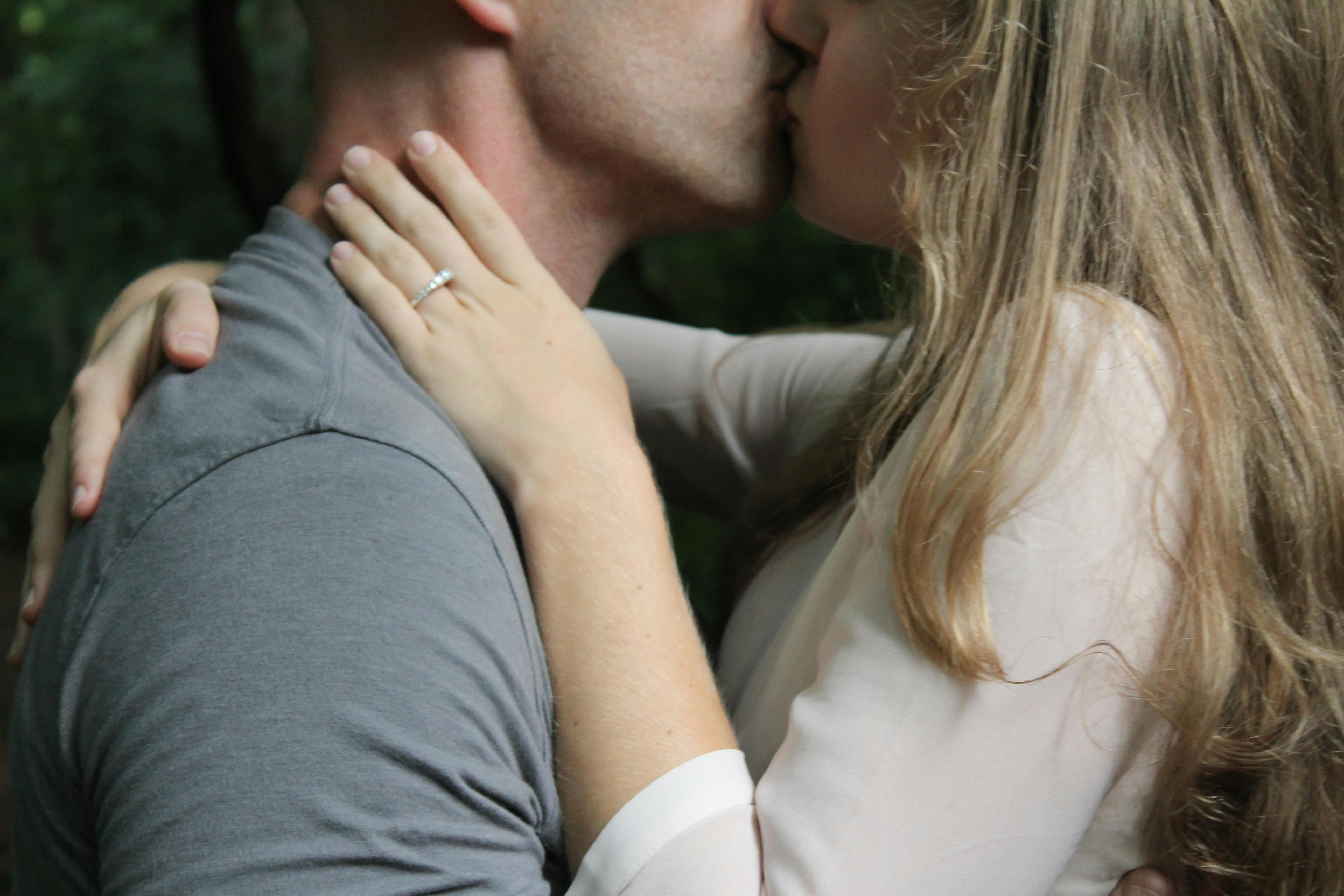 Romantic man kissing his girlfriend isolated on white background Stock  Photo - Alamy