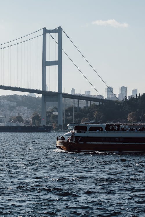 Ferry Boat Sailing near 15 July Martyrs Bridge in Istanbul, Turkey