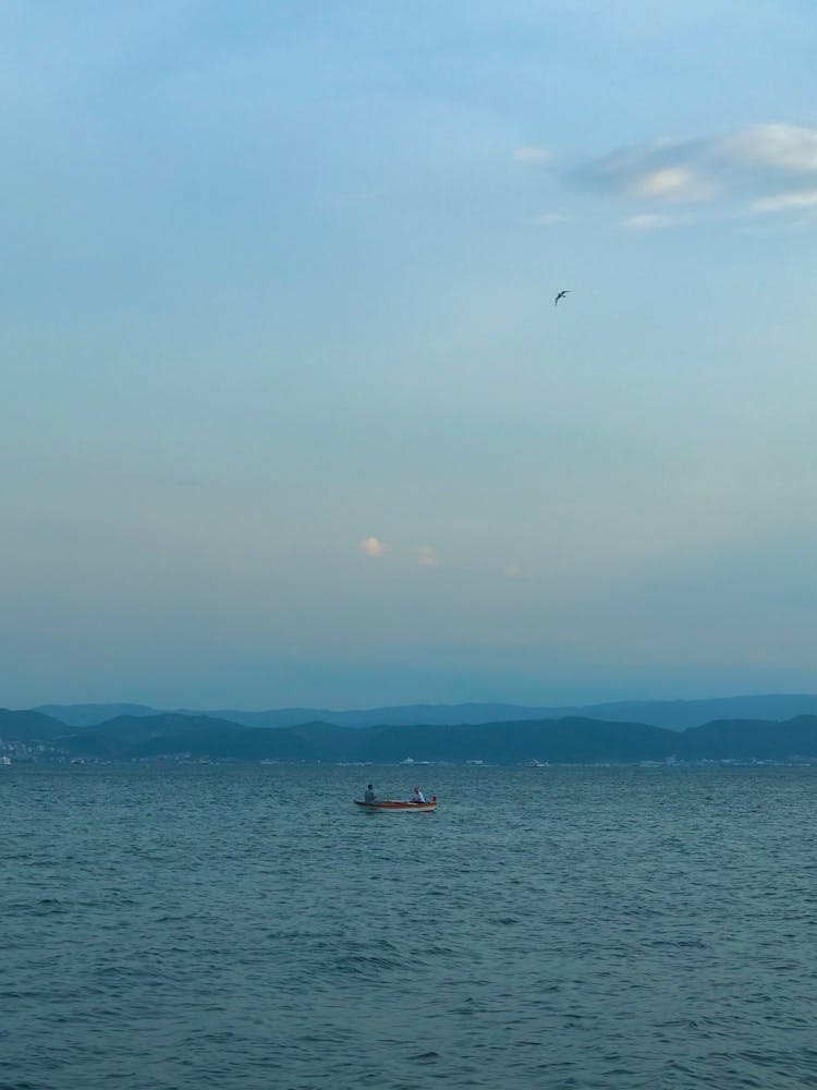 People Swimming On Boat On A Lake