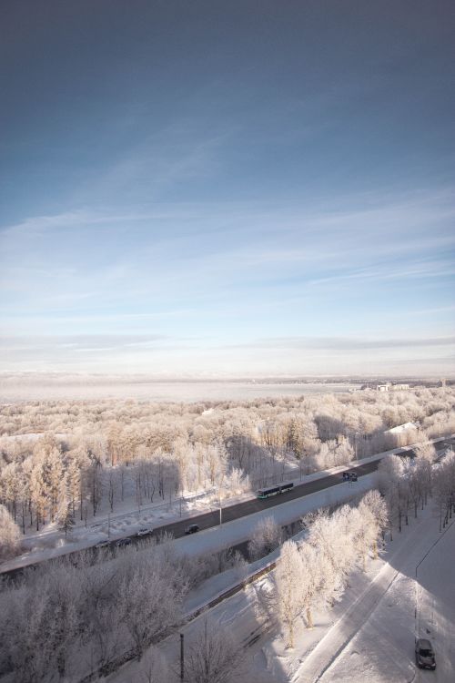Free Scenic aerial view of a snowy winter landscape with frosty trees and road. Stock Photo