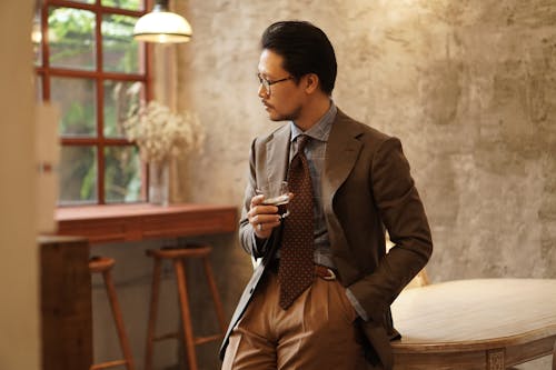 Elegant Man in a Suit Holding a Drink