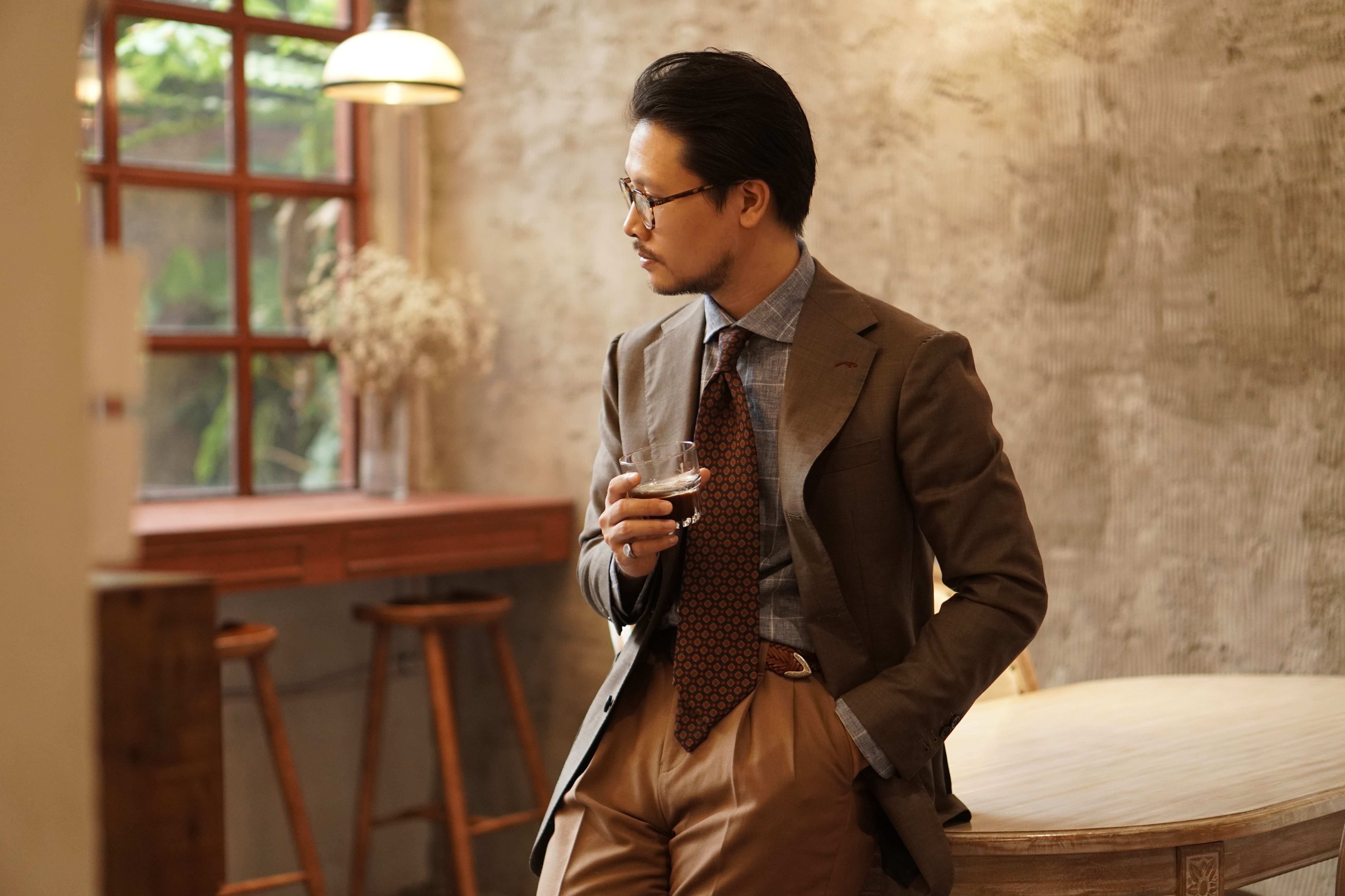 Elegant Man in a Suit Holding a Drink · Free Stock Photo