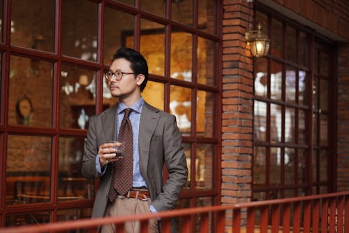 Elegant Man in a Suit Holding a Drink