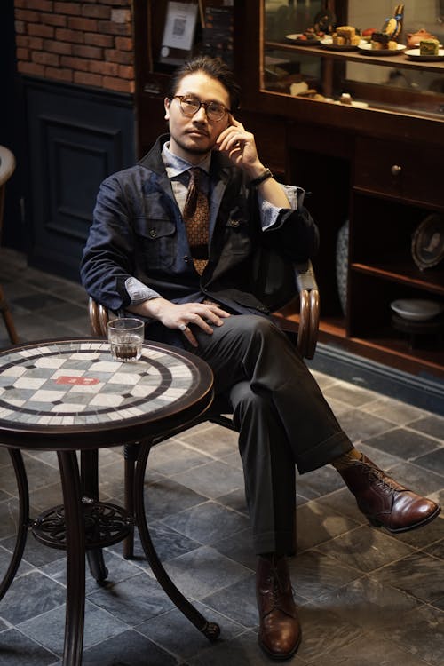 Elegant Man Sitting at the Table with a Drink