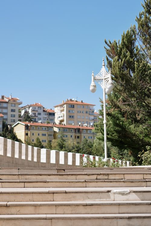 Free Urban scene with residential buildings, steps, and a clear blue sky. Stock Photo