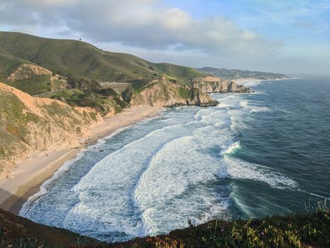 A breathtaking view of the rugged coastline in Pacifica, California, with waves crashing on the shore.