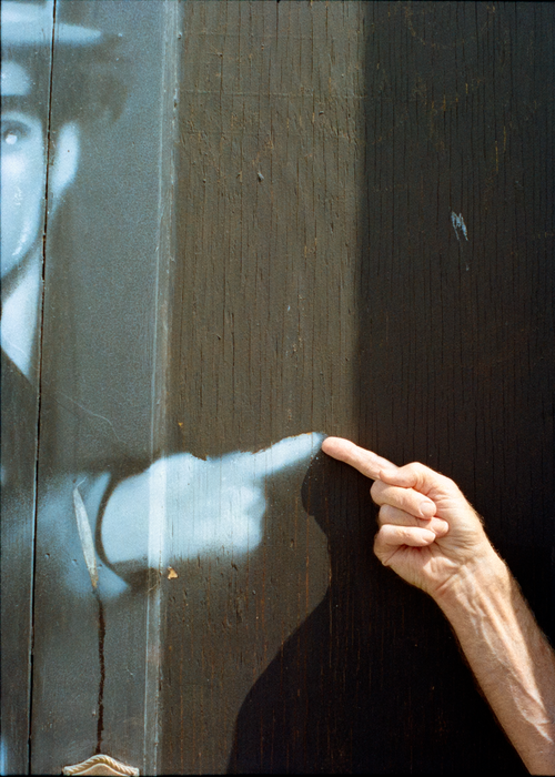Free Close-up of a hand gesturing at a vintage mural in an artistic setting. Stock Photo