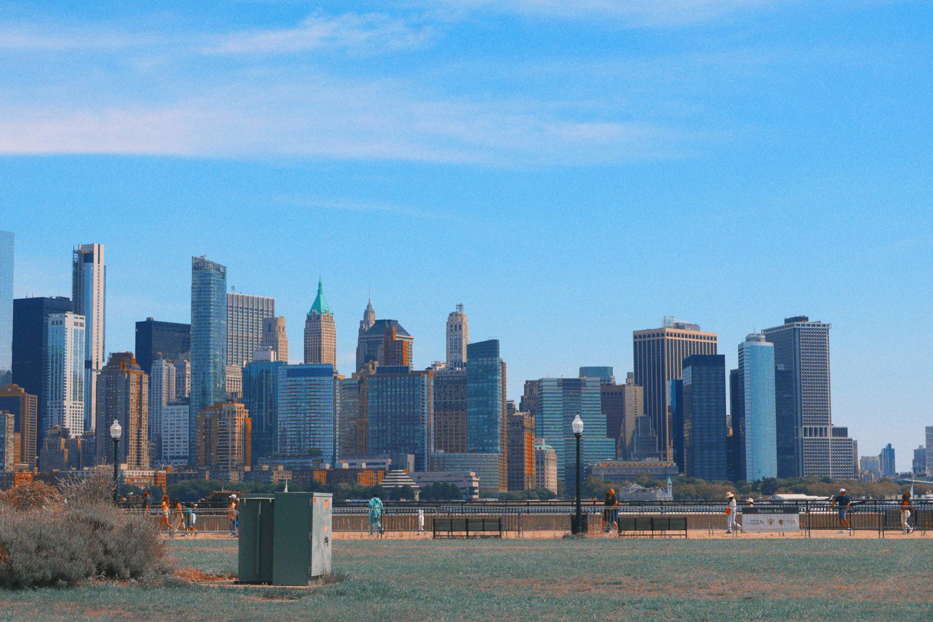 Scenic view of New York City skyline seen from New Jersey, showcasing modern skyscrapers on a clear day.