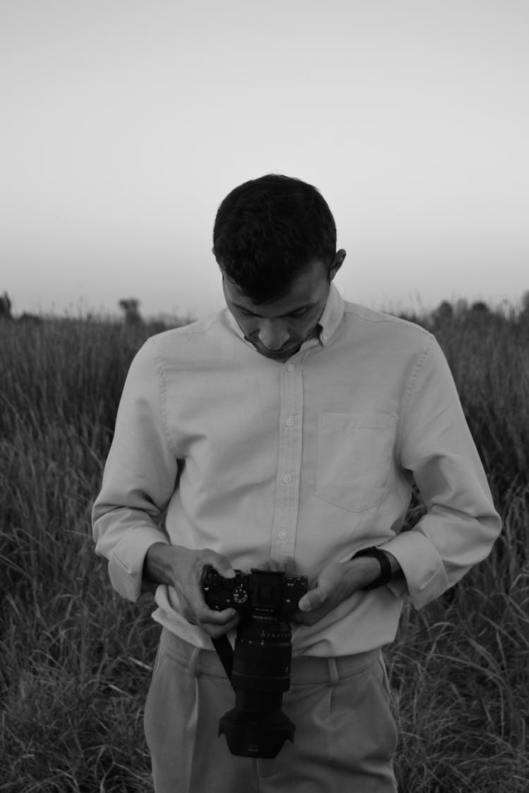 A Man Looking At The Camera Viewfinder