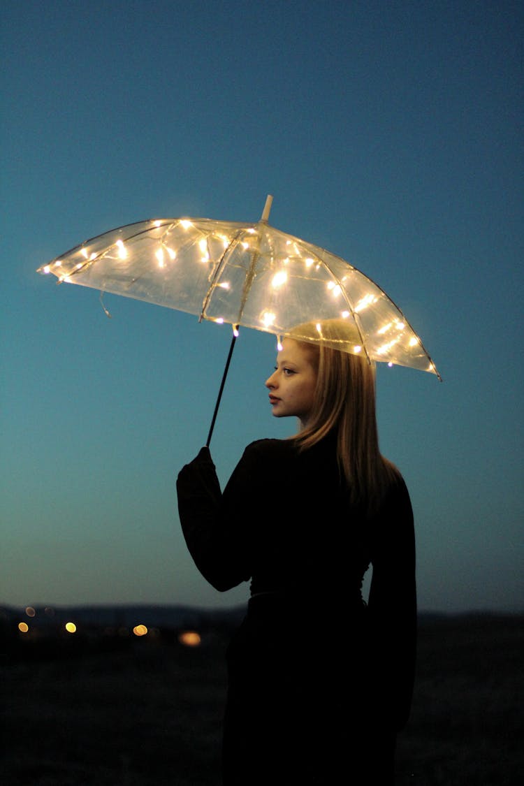 Woman Holding An Illuminated Umbrella
